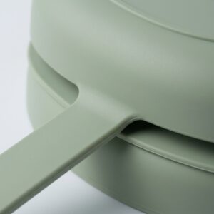 Close-up of the rounded release tab root and sealing rim on a silicone baby suction plate