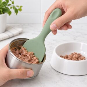Silicone pet food spatula scraping wet cat food from a metal can