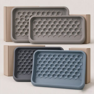 Raised perimeter edge and one-piece underside design of a custom silicone cat litter mat