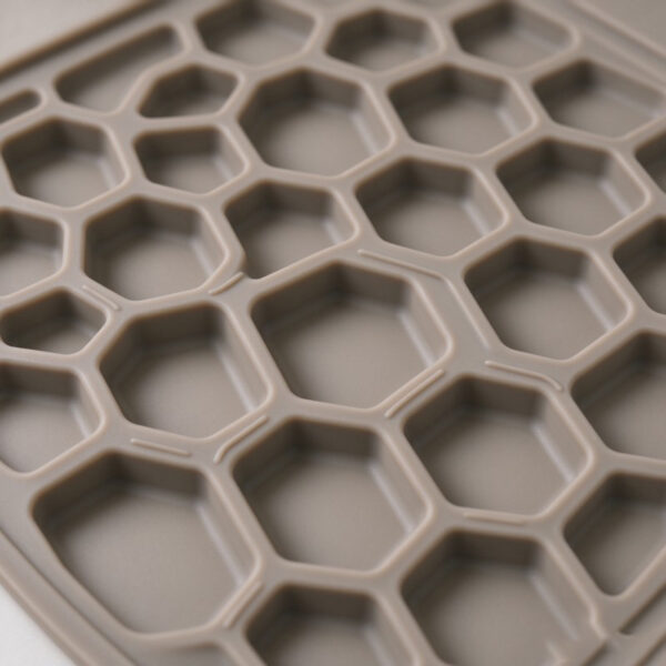 Close-up of shallow rounded collection cells on a custom silicone cat litter mat